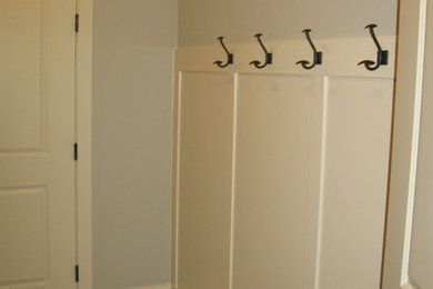 Laundry room - mid-sized galley vinyl floor laundry room idea in Seattle with an utility sink, shaker cabinets, white cabinets, laminate countertops and blue walls