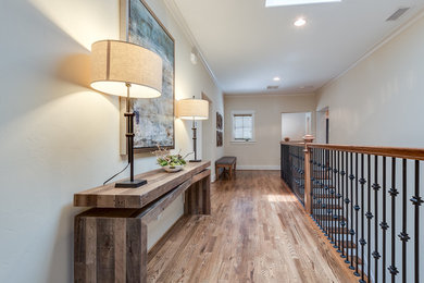 This is an example of a mid-sized transitional hallway in Dallas with medium hardwood floors and beige walls.