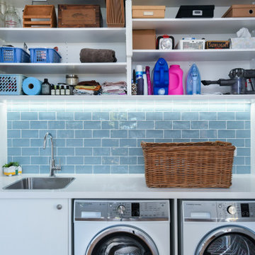 Laundry room with blue subway tile
