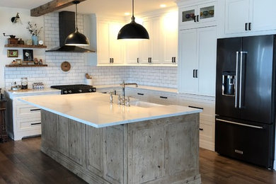 Photo of a large country l-shaped eat-in kitchen in Seattle with beaded inset cabinets, light wood cabinets and with island.