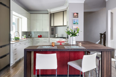 Trendy u-shaped medium tone wood floor and brown floor kitchen photo in DC Metro with an undermount sink, flat-panel cabinets, white cabinets, stainless steel appliances, a peninsula and beige countertops