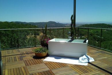 Patio fountain - mid-sized modern backyard patio fountain idea in San Francisco with decking and no cover