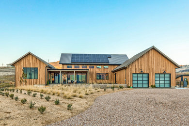 Modern brown one-story wood exterior home idea in Other with a metal roof