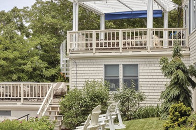 Deck photo in Boston with a pergola
