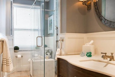 Example of a transitional blue tile and ceramic tile ceramic tile bathroom design in New York with furniture-like cabinets, distressed cabinets, a two-piece toilet, gray walls, an undermount sink and quartz countertops