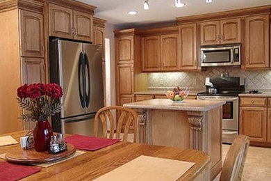 Mid-sized elegant l-shaped ceramic tile eat-in kitchen photo in Minneapolis with raised-panel cabinets, medium tone wood cabinets, granite countertops, beige backsplash, ceramic backsplash, stainless steel appliances and an island