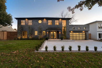 Example of a huge transitional black two-story brick house exterior design in Oklahoma City with a hip roof and a shingle roof
