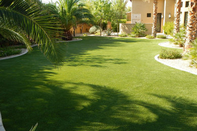 Inspiration for a large tropical partial sun backyard concrete paver garden path in Phoenix.