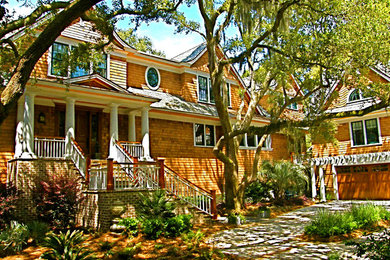 Large arts and crafts beige two-story exterior home photo in Charleston