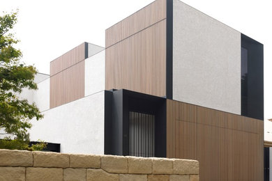 Contemporary two-storey exterior in Sydney with mixed siding.