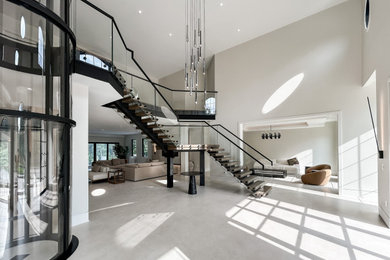 Inspiration for a large modern wooden floating open and glass railing staircase remodel in DC Metro