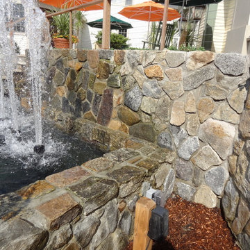 Cape Cod Inn with New England Stone Cladding, Retaining Walls, and Water Feature