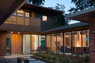 Inspiration for a large contemporary concrete floor entryway remodel in DC Metro with a medium wood front door