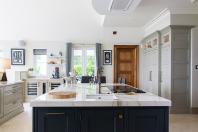 Inspiration for a large modern kitchen in Edinburgh with beaded cabinets, blue cabinets, composite countertops, porcelain flooring, multiple islands and white worktops.