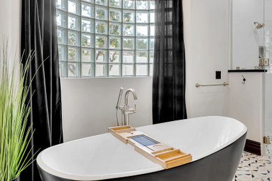 Bathroom - large transitional white tile and porcelain tile mosaic tile floor and single-sink bathroom idea in Phoenix with raised-panel cabinets, brown cabinets, an undermount sink, quartz countertops, a hinged shower door, black countertops and a built-in vanity