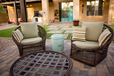 Inspiration for a mid-sized southwestern backyard stone patio remodel in Phoenix with a fire pit and a pergola