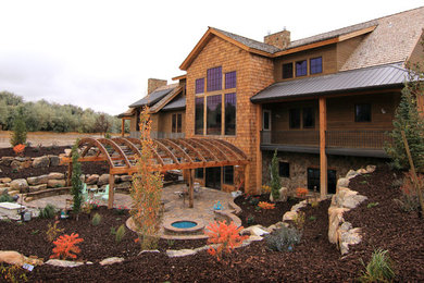 Large rustic brown three-story wood exterior home idea in San Diego with a shingle roof