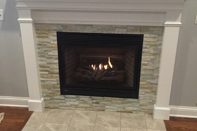 Example of a classic dark wood floor and brown floor family room design in Chicago with a standard fireplace, a tile fireplace and white walls