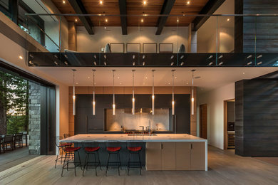 Trendy beige floor kitchen photo in Other with an undermount sink, flat-panel cabinets, black cabinets, white backsplash, stainless steel appliances and an island