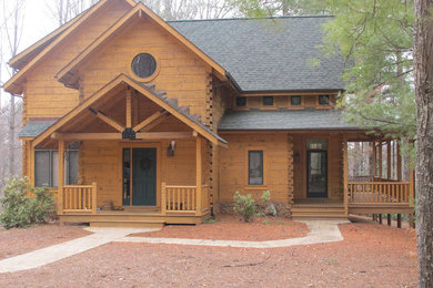 Large rustic brown two-story wood gable roof idea in Detroit