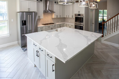 Example of a huge minimalist ceramic tile and white floor kitchen design in Houston