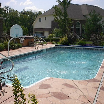 In ground pool with decorative concrete