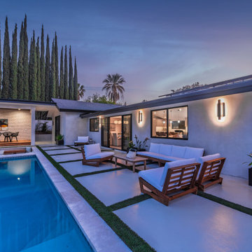 Poolside Lounge Against the Lit Rear Elevation