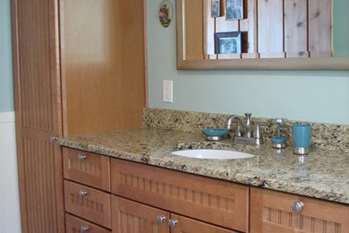 Bathroom - mid-sized coastal 3/4 ceramic tile bathroom idea with an undermount sink, granite countertops, shaker cabinets, medium tone wood cabinets and green walls
