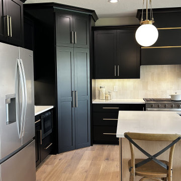 Black and Maple Wheat Kitchen with Brass Banded Hood