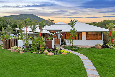 Inspiration for a tropical white exterior in Cairns with a hip roof.