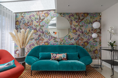Contemporary open plan living room feature wall in Cambridgeshire with multi-coloured walls, porcelain flooring, beige floors, a vaulted ceiling and wallpapered walls.