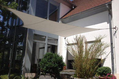 Inspiration for a contemporary deck in Nuremberg with a container garden and an awning.