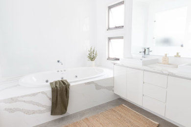 Bathroom - mid-sized modern master white tile and stone slab double-sink bathroom idea in San Francisco with flat-panel cabinets, white cabinets, white walls, a drop-in sink, quartz countertops, a hinged shower door, white countertops and a built-in vanity