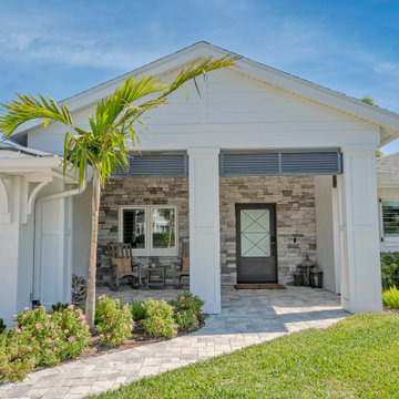 Elegant Coastal Entrance Framed by Stone and Tropical Greenery