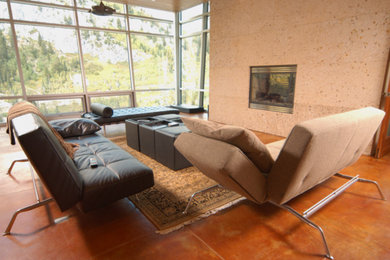 Living room - large modern formal and open concept concrete floor and brown floor living room idea in San Diego with beige walls, a standard fireplace, a concrete fireplace and no tv