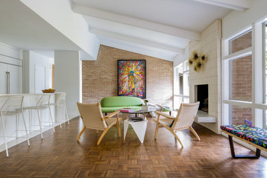 Living room - 1960s open concept dark wood floor, brown floor, exposed beam and vaulted ceiling living room idea in Dallas with white walls, a standard fireplace and a brick fireplace