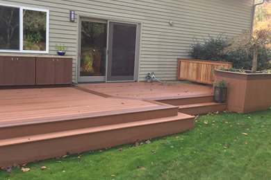Example of a mid-sized country backyard outdoor kitchen deck design in Seattle with no cover