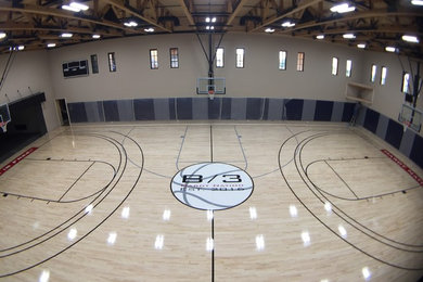 Large traditional indoor sport court in Phoenix with beige walls and light hardwood floors.