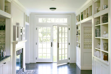 Large elegant dark wood floor entryway photo in Chicago with white walls and a white front door