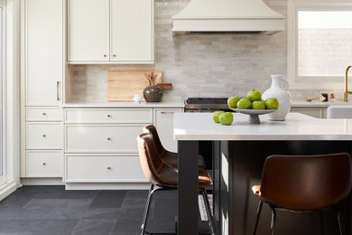 Large u-shaped slate floor, black floor and vaulted ceiling kitchen photo in Toronto with an undermount sink, shaker cabinets, white cabinets, quartzite countertops, white backsplash, porcelain backsplash, stainless steel appliances, an island and white countertops