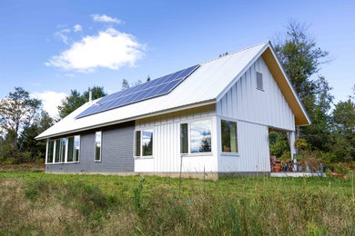 Trendy exterior home photo in Burlington with a metal roof