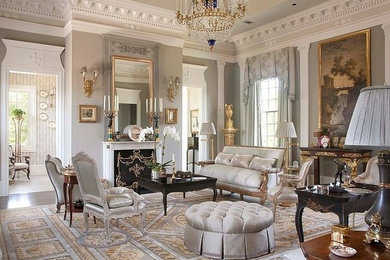Inspiration for a large timeless dark wood floor living room remodel in New York with beige walls, a standard fireplace and a wood fireplace surround