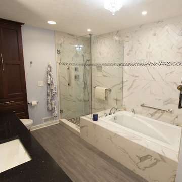White and Gray MasterBath with Marble Look and Herringbone Tiled Shower