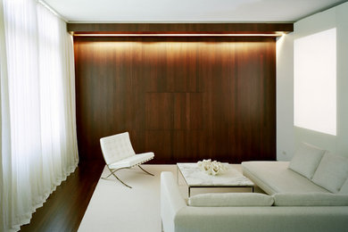 Example of a minimalist living room design in New York with white walls