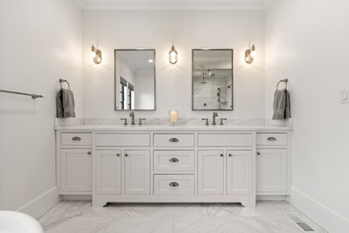 This is an example of a mid-sized transitional master bathroom in Boston with shaker cabinets, white cabinets, a freestanding tub, an undermount sink, a double vanity and a built-in vanity.