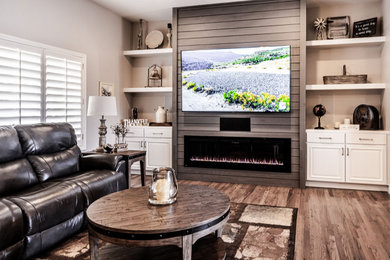 Photo of a medium sized rural open plan living room in Phoenix with grey walls, medium hardwood flooring, a ribbon fireplace, a timber clad chimney breast, a wall mounted tv and brown floors.