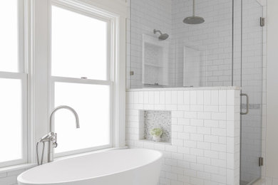 Bathroom - mid-sized modern master porcelain tile and white floor bathroom idea in Seattle with white walls, a hinged shower door and a niche