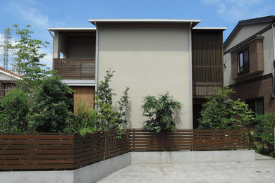 Design ideas for a modern two-storey house exterior in Tokyo Suburbs with a gable roof and a metal roof.