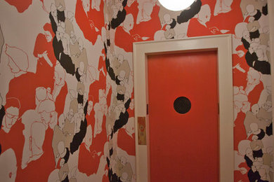 Large transitional medium tone wood floor and beige floor entryway photo in New York with a red front door