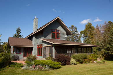 Example of a mid-sized mountain style blue two-story wood exterior home design in Minneapolis with a shingle roof